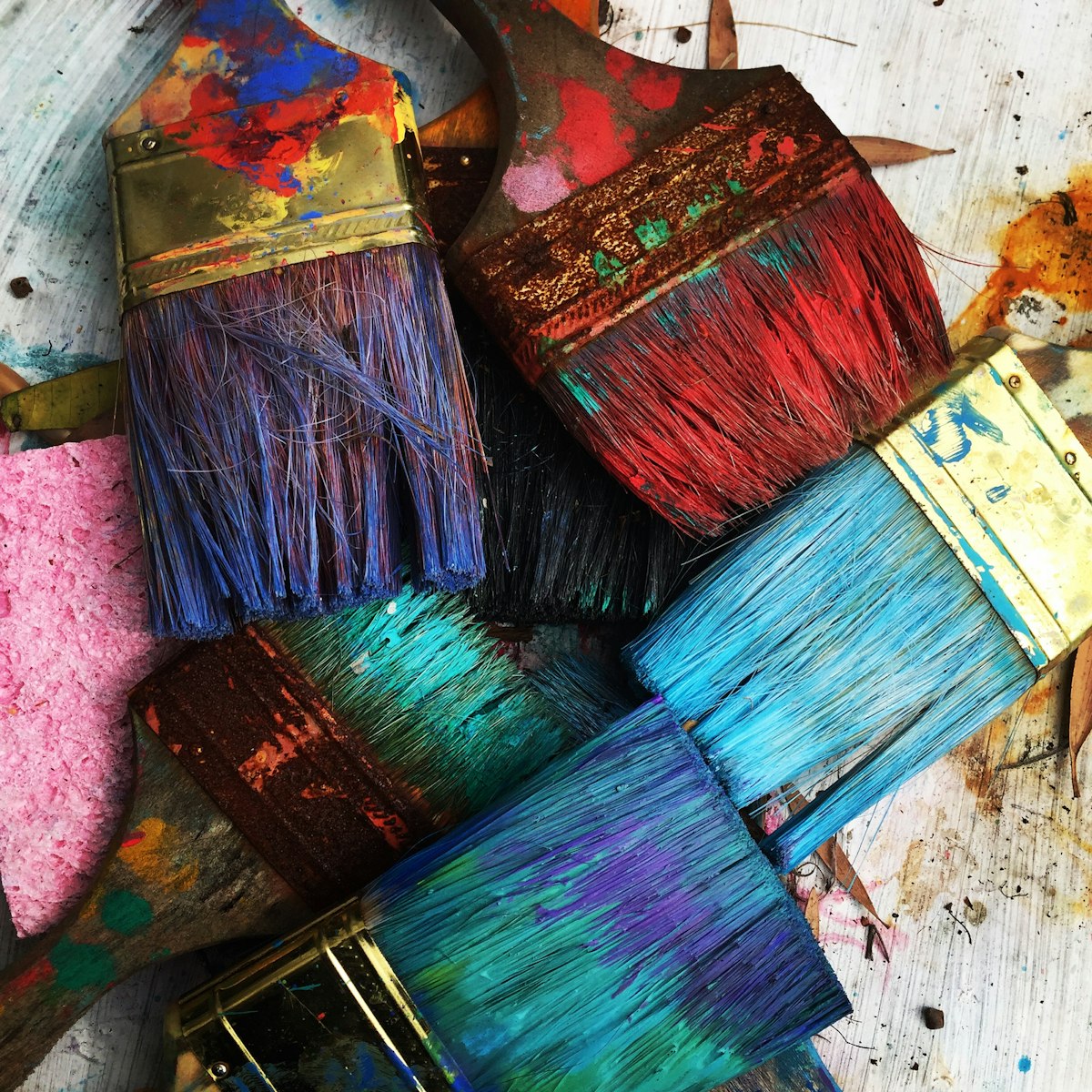 A cluster of colourful, well-used artist's paintbrushes